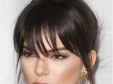 Black Hairstyles with Buns and Bangs Kendall Jenner Straight Dark Brown Bun Choppy Bangs Hairstyle