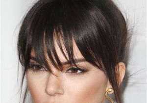 Black Hairstyles with Buns and Bangs Kendall Jenner Straight Dark Brown Bun Choppy Bangs Hairstyle