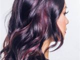 Black Hairstyles with Red Highlights Glossy Black Waves with Muted Burgundy Highlights