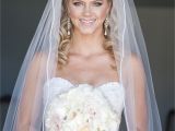 Bridal Hairstyles Half Up Half Down with Veil and Tiara Bride Dress Wedding Down Bouquet Silhouette Cathedral Veil Make Up