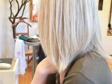 Feather Cut Hairstyle for Girls toning with All Over Highlights On A Natural Dirty Blonde
